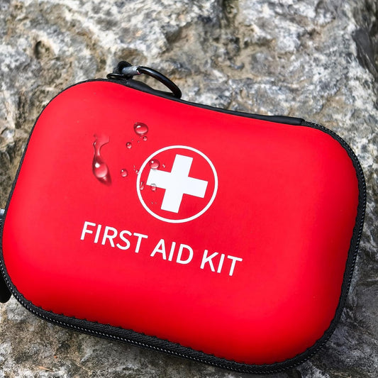 Red utility kit with a white cross symbol on a stone background