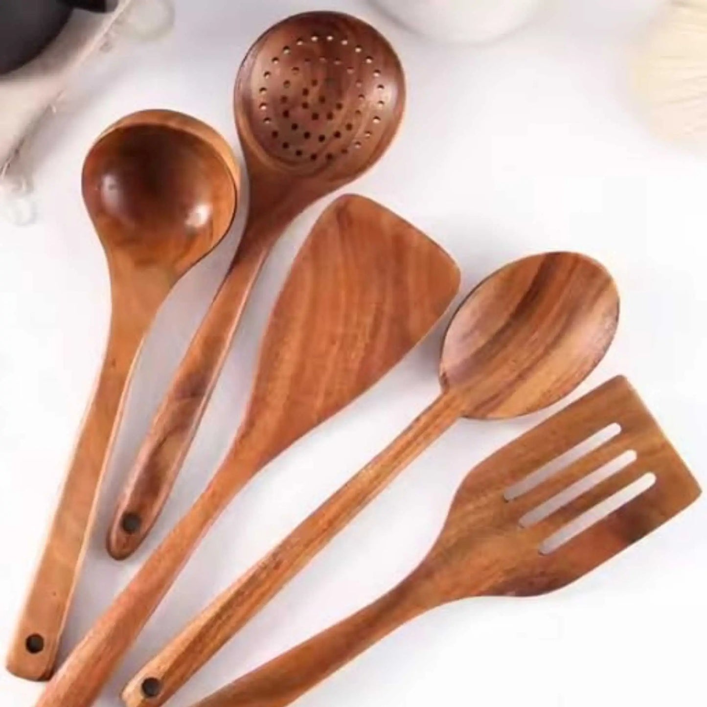 Close-up: wooden spoon set for cooking, spatulas, ladle. Essential wooden utensils kitchen tools.