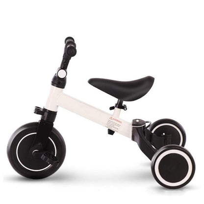 White and black balance bike on a white background
