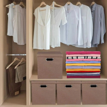 Brown folding storage boxes for clothes on a closet shelf, beside folded garments.