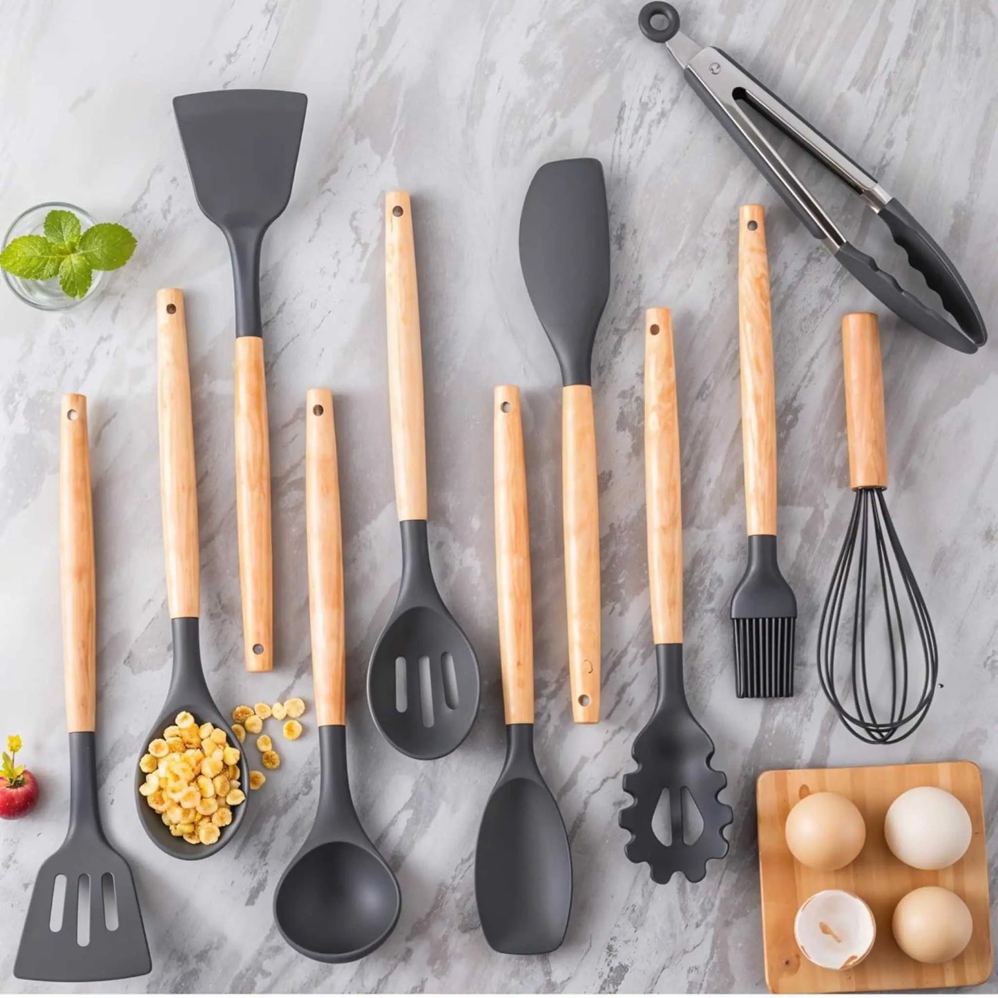 Stylish flat lay of a kitchen cooking utensils set: grey silicone tools with wood handles, perfect as a versatile utensils set for kitchen.