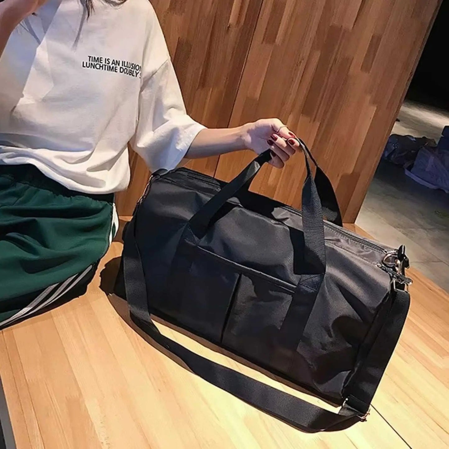 Holding a big duffle bags by handles, a versatile lg duffle bags for travel and daily use.