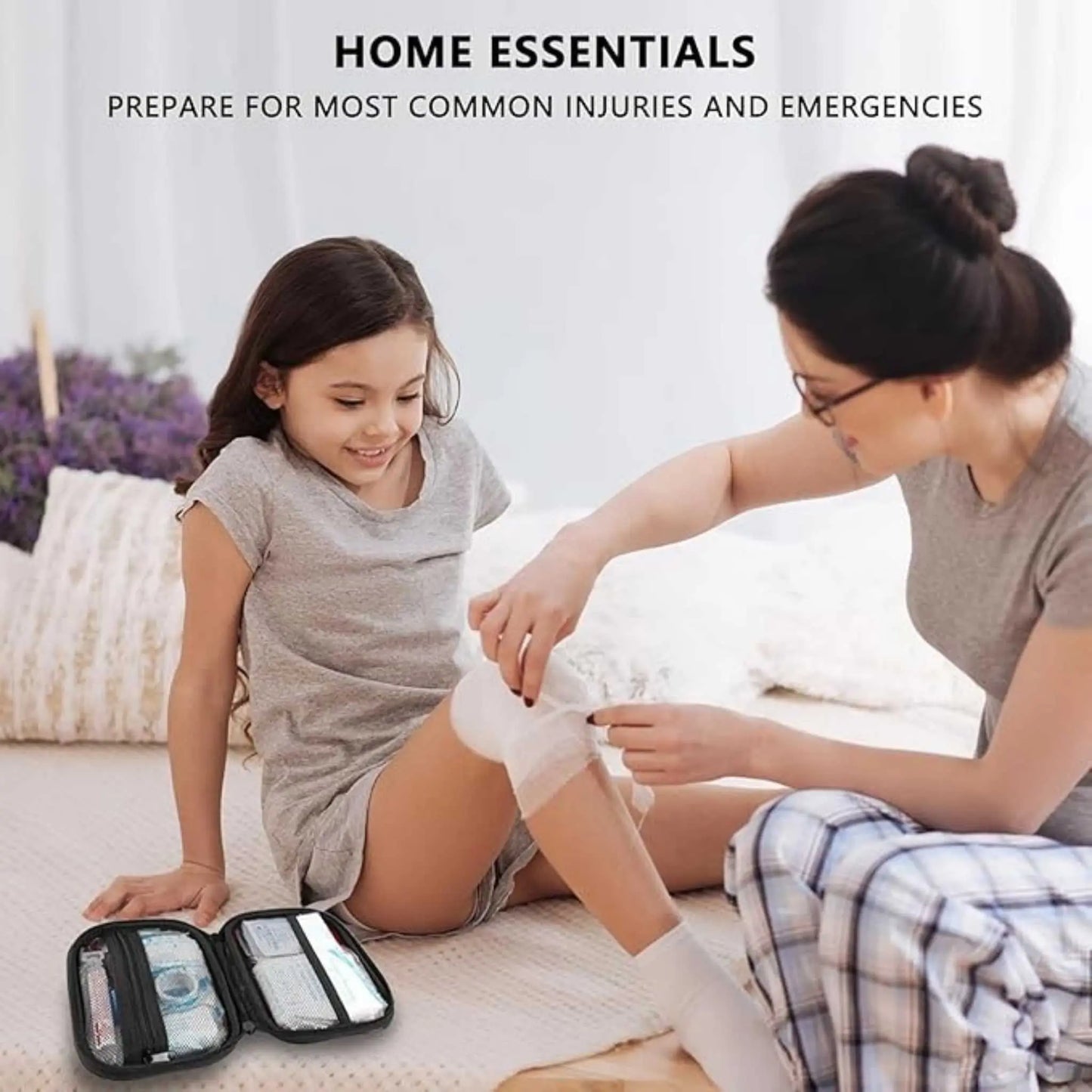 Woman using a bandage from the first aid kit set on a child. Essential home medical kit.