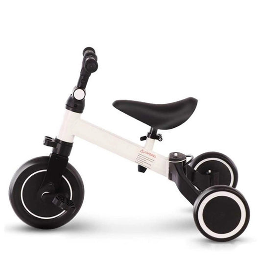 A white and black toddler tricycle with a large front wheel and two small rear wheels, designed as a balance bike.
