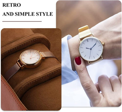 Gold watch with brown strap on a brown surface and worn on a wrist.